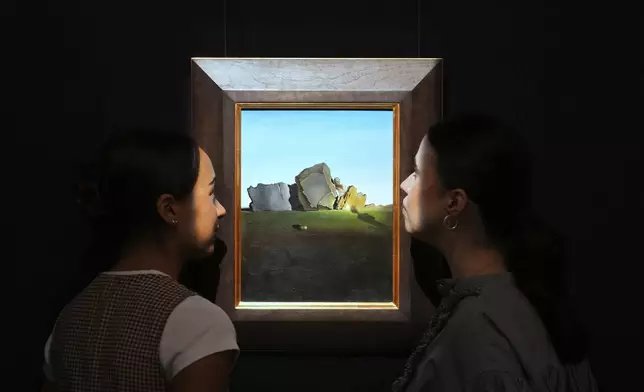 A painting by Salvador Dali called Symbiose de la tete aux coquillages is displayed at Sotheby's auction rooms, the painting estimated at 2-3 million US dollars is part of a collection of surrealist masterpieces unveiled in London ahead of their sale in New York, Friday, Sept. 19, 2025. (AP Photo/Kirsty Wigglesworth)