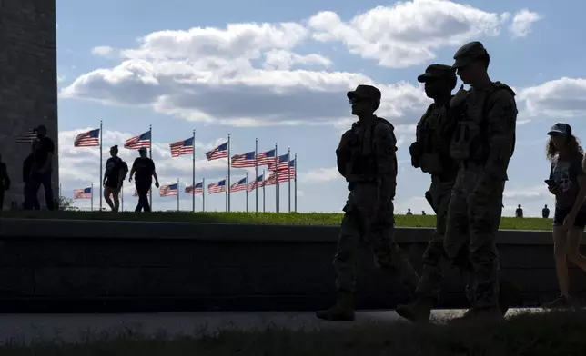 Members of the Louisiana National Guard patrol the National Mall, Sunday, Sept. 7, 2025, in Washington. (AP Photo/Jose Luis Magana)