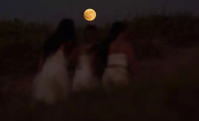 A blood moon rises ahead of a Lunar Eclipse in Hadera, Israel, Sunday, Sept. 7, 2025. (AP Photo/Ariel Schalit)