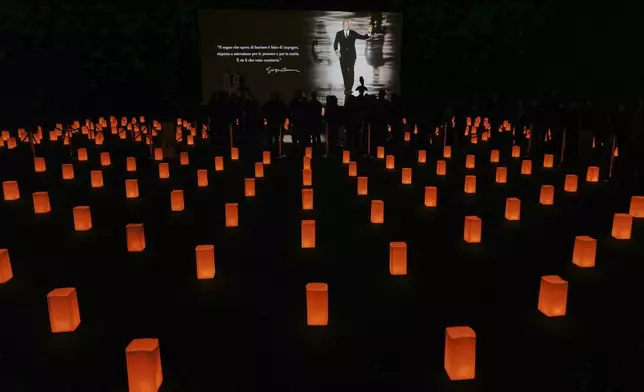 People pay their respects to fashion designer Giorgio Armani, lying in state at the Armani/Teatro in Milan, northern Italy, Saturday, Sept. 6, 2025. (AP Photo/Antonio Calanni)