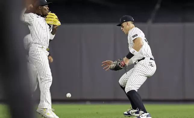 New York Yankees outfielder Aaron Judge, right and Jazz Chisholm Jr. watch a single hit by Toronto Blue Jays' Bo Bichette fall between them during the fifth inning of a baseball game Friday, Sept. 5, 2025, in New York. (AP Photo/Adam Hunger)