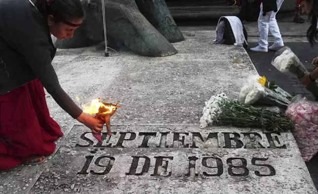 An Indigenous woman uses incense for a blessing at the 1985 earthquake memorial during a ceremony marking the quake's 40th anniversary in Mexico City, Friday, Sept. 19, 2025. (AP Photo/Marco Ugarte)