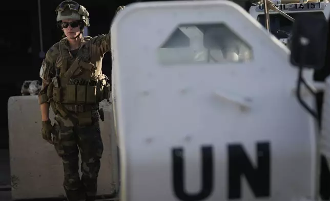 A French U.N. peacekeeper stands beside an armored vehicle at his base, waiting to move with his unit for a patrol along the Lebanese-Israeli border in Deir Kifa, southern Lebanon, Wednesday, Aug. 20, 2025. (AP Photo/Hussein Malla)
