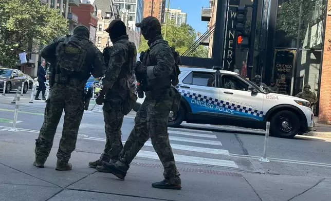 Federal agents patrol downtown Chicago, Sunday, Sept. 28, 2025. (AP Photo/Sophia Tareen)