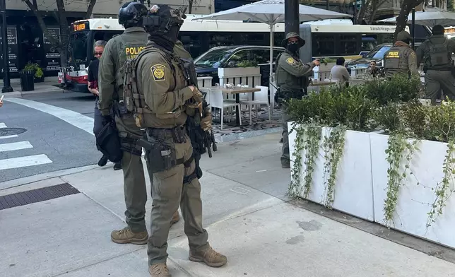 Federal agents patrol downtown Chicago, Sunday, Sept. 28, 2025. (AP Photo/Sophia Tareen)