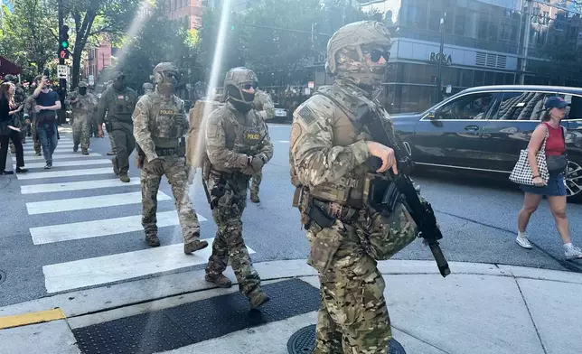 Federal agents patrol downtown Chicago, Sunday, Sept. 28, 2025. (AP Photo/Sophia Tareen)