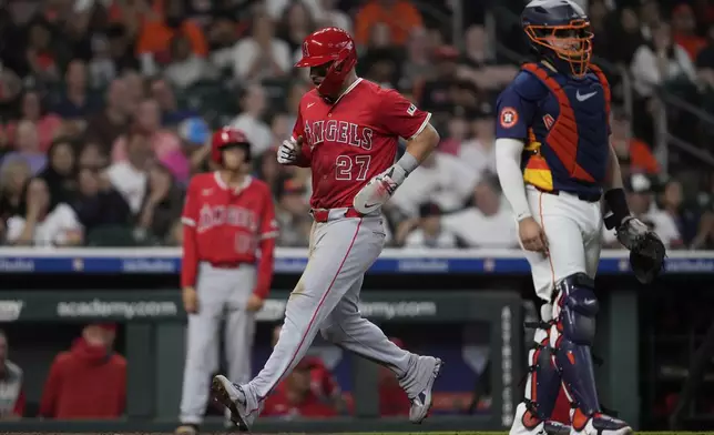 Los Angeles Angels designated hitter Mike Trout (27) scores off of a single hit by Luis Rengifo during the eighth inning of a baseball game against the Houston Astros in Houston, Sunday, Aug. 31, 2025. (AP Photo/Ashley Landis)