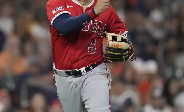 Los Angeles Angels third baseman Yoan Moncada (5) throws to firs to out Houston Astros' Christian Walker during the fourth inning of a baseball game in Houston, Sunday, Aug. 31, 2025. (AP Photo/Ashley Landis)