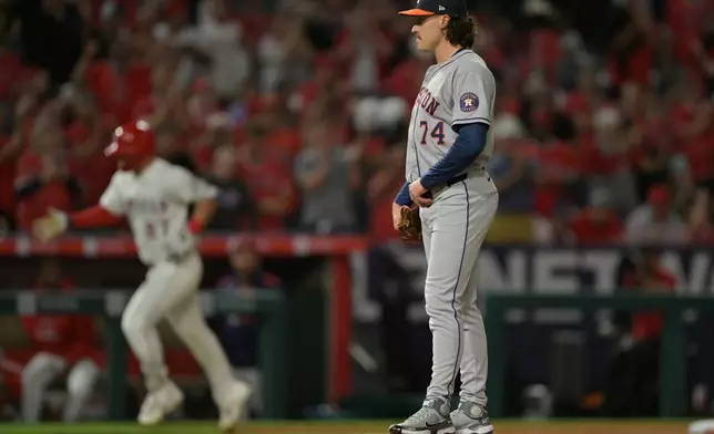 Houston Astros relief pitcher Bryan King (74) stands on the mound as Los Angeles Angels' Mike Trout rounds the bases after hitting a solo home run during the eighth inning of a baseball game Friday, Sept. 26, 2025, in Anaheim, Calif. (AP Photo/Jayne Kamin-Oncea)