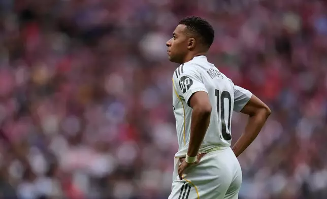 Real Madrid's Kylian Mbappe stands at the pitch during the Spanish La Liga soccer match between Atletico Madrid and Real Madrid at Metropolitano stadium, in Madrid, Spain, Saturday, Sept. 27, 2025. (AP Photo/Manu Fernandez)