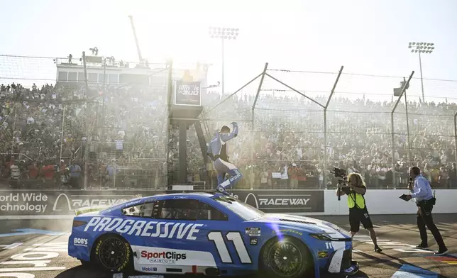 Denny Hamlin, center, celebrates after winning a NASCAR Cup Series auto race at World Wide Technology Raceway, Sunday, Sept. 7, 2025, in Madison, Ill. (AP Photo/Connor Hamilton)