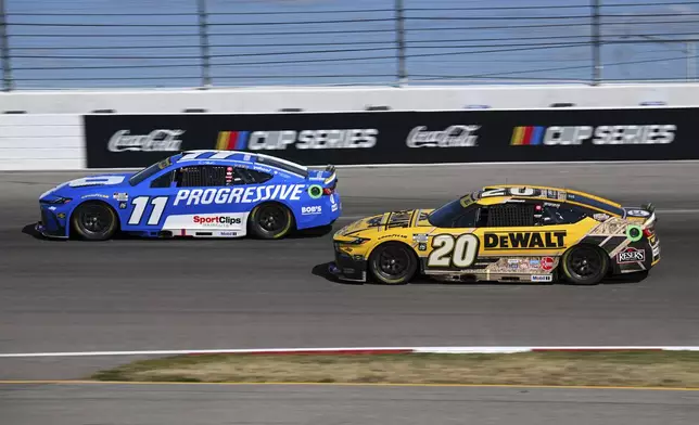 Denny Hamlin (11) and Christopher Bell (20) compete during a NASCAR Cup Series auto race at World Wide Technology Raceway, Sunday, Sept. 7, 2025, in Madison, Ill. (AP Photo/Connor Hamilton)