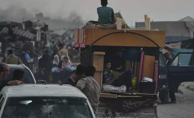 Displaced Palestinians fleeing northern Gaza Strip move with their belongings along the Sea Road, in Gaza City, Monday, Sept. 1, 2025. (AP Photo/Jehad Alshrafi)