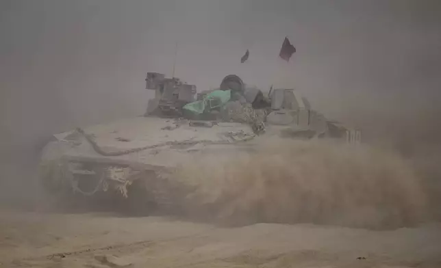 Israeli soldiers move on armored personnel carriers (APC) near the Israeli-Gaza border, in southern Israel, Tuesday, Sept. 2, 2025. (AP Photo/Ohad Zwigenberg)