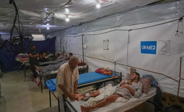Patients receive care at a field hospital run by the British humanitarian medical NGO UK-Med in Muwasi, near Khan Younis, southern Gaza Strip, Saturday, Sept. 27, 2025. (AP Photo/Jehad Alshrafi)