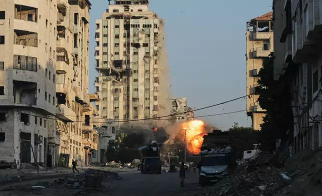 Smoke and fire rises from an Israeli airstrike on the Macca Tower, a high-rise building in Gaza City, Sunday, Sept. 28, 2025, following a prior warning issued by the Israeli army. (AP Photo/Yousef Al Zanoun)
