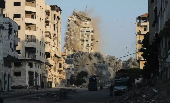 Smoke rises from an Israeli airstrike on the Macca Tower, a high-rise building in Gaza City, Sunday, Sept. 28, 2025, following a prior warning issued by the Israeli army. (AP Photo/Yousef Al Zanoun)