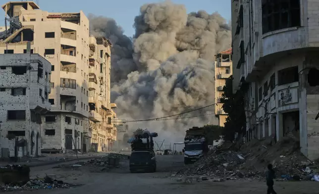 Smoke rises from an Israeli airstrike on the Macca Tower, a high-rise building in Gaza City, Sunday, Sept. 28, 2025, following a prior warning issued by the Israeli army. (AP Photo/Yousef Al Zanoun)