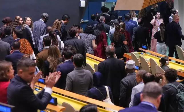 Delegates leave as Israel Prime Minister Benjamin Netanyahu arrives to address the 80th session of the United Nations General Assembly, Friday, Sept. 26, 2025. (AP Photo/Richard Drew)