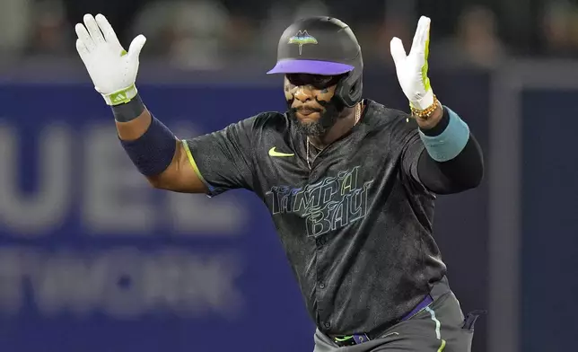 Tampa Bay Rays' Yandy Díaz celebrates after his double off Boston Red Sox pitcher Garrett Crochet during the first inning of a baseball game Friday, Sept. 19, 2025, in Tampa, Fla. (AP Photo/Chris O'Meara)