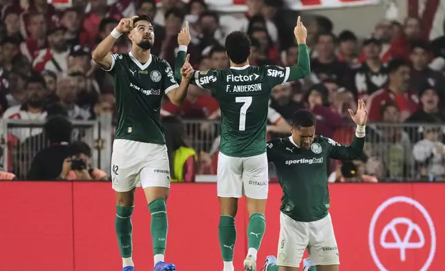 Vitor Roque of Brazil's Palmeiras, right, celebrates scoring his side's second goal against Argentina's River Plate during a Copa Libertadores quarterfinal soccer match at the Monumental stadium in Buenos Aires, Argentina, Wednesday, Sept. 17, 2025. (AP Photo/Gustavo Garello)