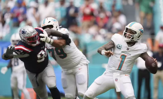 Miami Dolphins' Tua Tagovailoa throws during the second half of an NFL football game against the New England Patriots Sunday, Sept. 14, 2025, in Miami Gardens, Fla. (AP Photo/Rebecca Blackwell)