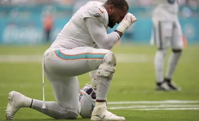Miami Dolphins' Bradley Chubb reacts after teammate Chop Robinson is hurt during the second half of an NFL football game against the New England Patriots Sunday, Sept. 14, 2025, in Miami Gardens, Fla. (AP Photo/Rebecca Blackwell)