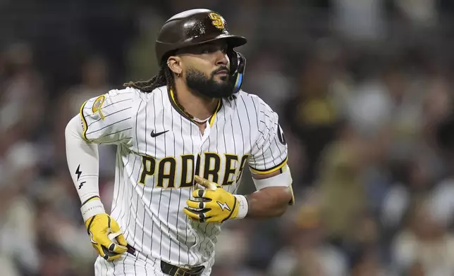 San Diego Padres' Fernando Tatis Jr. watches his flyout during the fifth inning of a baseball game against the Baltimore Orioles Tuesday, Sept. 2, 2025, in San Diego. (AP Photo/Gregory Bull)