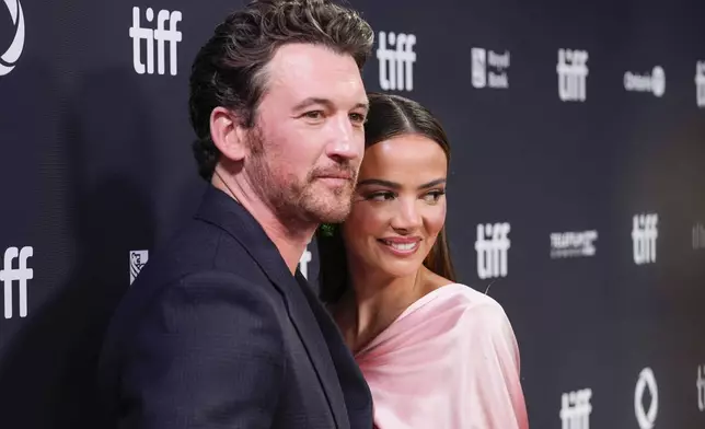 Miles Teller, left, and Keleigh Sperry attend the premiere of "Eternity" during the Toronto International Film Festival on Sunday, Sept. 7, 2025, at Roy Thomson Hall in Toronto. (AP Photo/Chris Pizzello)
