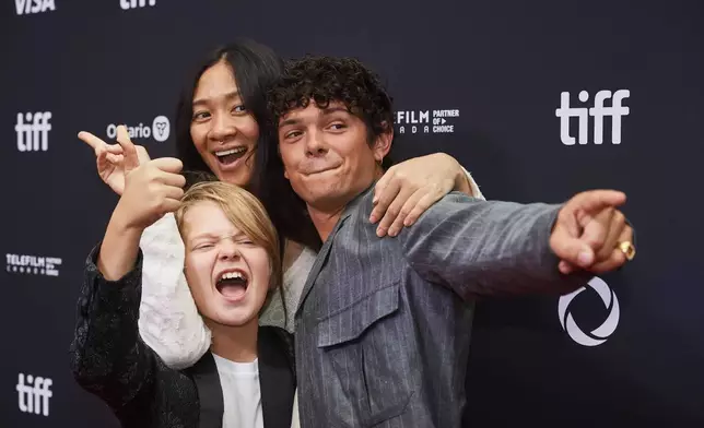 Actor Jacobi Jupe, left to right, director Chloé Zhao and actor Noah Jupe are photographed on the red carpet for the film "Hamnet" during the Toronto International Film Festival in Toronto, on Sunday, Sept. 7, 2025. (Sammy Kogan/The Canadian Press via AP)
