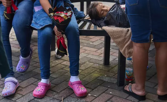 People wait for loved ones from Guatemala deported from the United States outside La Aurora International Airport, in Guatemala City, Sunday, Aug. 31, 2025. (AP Photo/Moises Castillo)