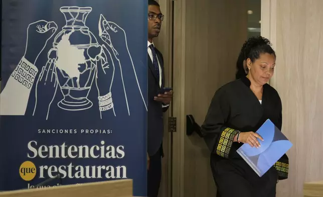 Ana Manuela Ochoa, member of Colombia's peace tribunal, arrives to read a guilty sentence for war crimes by former leaders of the Revolutionary Armed Forces of Colombia, FARC, in Bogota, Colombia, Tuesday, Sept. 16, 2025. (AP Photo/Fernando Vergara)