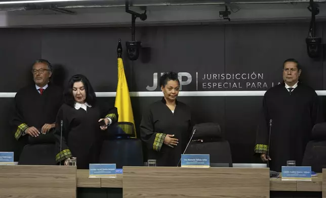 Members of Colombia's peace tribunal arrive to read a guilty sentence for war crimes by former leaders of the Revolutionary Armed Forces of Colombia, FARC, in Bogota, Colombia, Tuesday, Sept. 16, 2025. (AP Photo/Fernando Vergara)