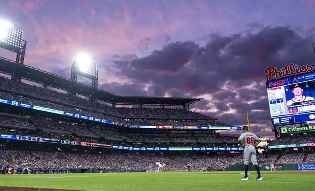 Philadelphia Phillies starting pitcher Jesus Luzardo, center, delivers to Atlanta Braves' Sean Murphy, left, during the third inning of a baseball game, Sunday, Aug. 31, 2025, in Philadelphia. (AP Photo/Chris Szagola)