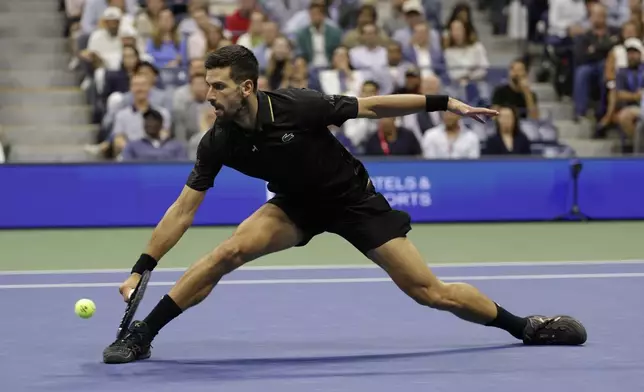 Novak Djokovic, of Serbia, returns a shot against Taylor Fritz, of the United States, during the quarterfinal round of the U.S. Open tennis championships, Tuesday, Sept. 2, 2025, in New York. (AP Photo/Adam Hunger)
