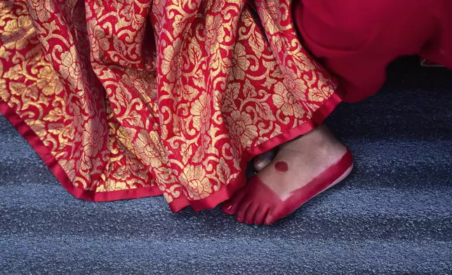 A young Newar girl, dressed to represent divine female energy, waits for Kumari Puja, a ritual during which she will be worshipped at Hanuman Dhoka, Basantapur Durbar Square, Kathmandu, Nepal, Friday, Sept. 5, 2025. (AP Photo/Niranjan Shrestha)