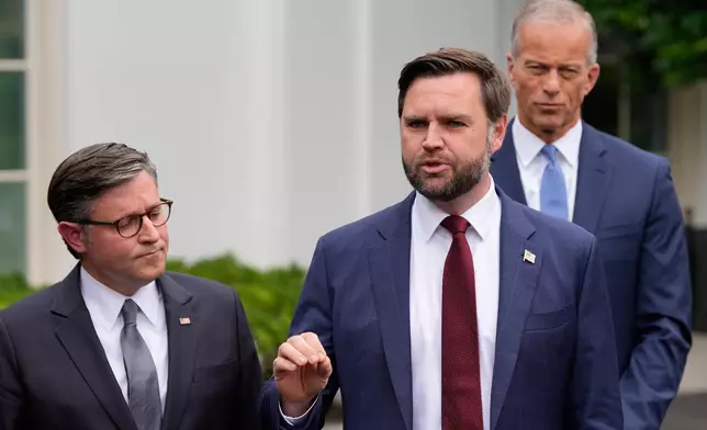 Vice President JD Vance talks to reporters outside the West Wing of the White House, Monday, Sept. 29, 2025, in Washington, as House Speaker Mike Johnson of La., and Senate Majority Leader John Thune, R-S.D., listen. (AP Photo/Alex Brandon)