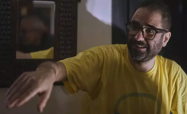 Pro-democracy Egyptian-British activist Alaa Abd el-Fattah, who was in prison for almost all of the past 12 years, speaks to his family as he arrives at his home, after a presidential pardon, in Cairo, Egypt, Tuesday, Sept. 23, 2025. (AP Photo/Amr Nabil)