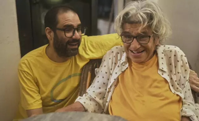Pro-democracy activist Alaa Abd el-Fattah who was in prison for almost all of the past 12 years, hugs his mother Laila Soueif, as he arrives at his home, after a presidential pardon, in Cairo, Egypt, Tuesday, Sept. 23, 2025. (AP Photo/Amr Nabil)