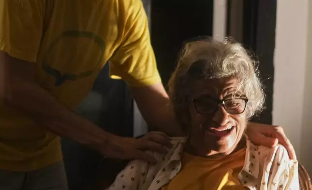 Pro-democracy activist Alaa Abd el-Fattah, left, who was in prison for almost all of the past 12 years, hugs his mother Laila Soueif, as he arrives at his home, after a presidential pardon, in Cairo, Egypt, Tuesday, Sept. 23, 2025. (AP Photo/Amr Nabil)