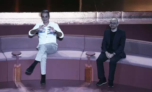 Greece's Prime Minister Kyriakos Mitsotakis, left, and Demis Hassabis, CEO of Google's artificial intelligence research company DeepMind discuss the future of AI, ethics and democracy during an event at the Odeon of Herodes Atticus, in Athens, Greece, Friday, Sept. 12, 2025. (AP Photo/Thanassis Stavrakis)