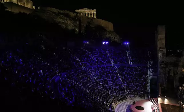 Demis Hassabis, CEO of Google's artificial intelligence research company DeepMind, bottom right, and Greece's Prime Minister Kyriakos Mitsotakis, bottom center, discuss the future of AI, ethics and democracy during an event at the Odeon of Herodes Atticus, under Acropolis ancient hill, in Athens, Greece, Friday, Sept. 12, 2025. (AP Photo/Thanassis Stavrakis)