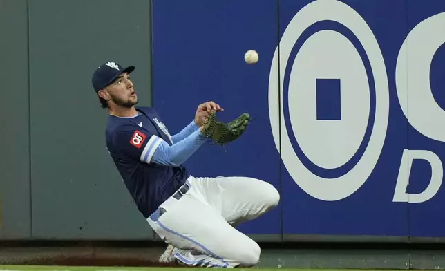 Kansas City Royals right fielder Jack Cagliaone catches a fly foul ball for the out 0n Minnesota Twins' Byron Buxton during the fifth inning of a baseball game Friday, Sept. 5, 2025, in Kansas City, Mo. (AP Photo/Charlie Riedel)