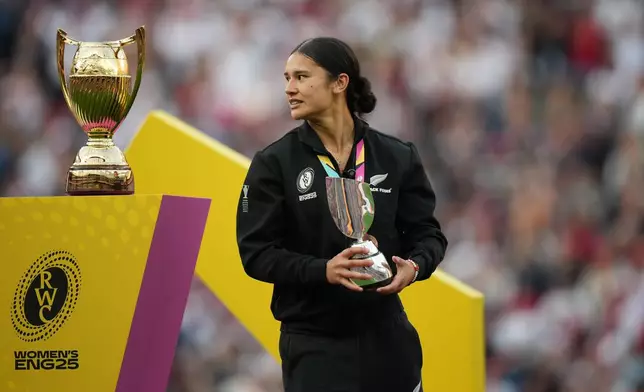 New Zealand's Braxton Sorensen-McGee walks past a World Cup trophy after receiving a tournament best scorer trophy at the end of the Women's Rugby World Cup final match between England and Canada at the Allianz Stadium, Twickenham, London, Saturday, Sept. 27, 2025. (AP Photo/Alastair Grant)