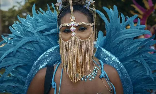 FILE - A reveler poses for a picture during the West Indian Day Parade on Sept. 2, 2024, in the Brooklyn borough of New York. (AP Photo/Andres Kudacki, File)
