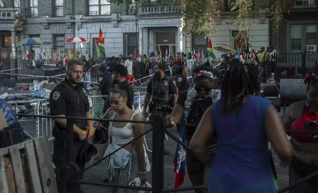 People flee the scene of a double shooting during the West Indian Day Parade on Monday, Sept. 1, 2025, in the Brooklyn borough of New York. (AP Photo/Olga Fedorova)
