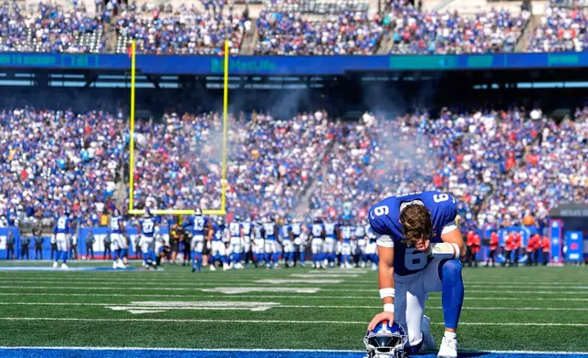 New York Giants quarterback Jaxson Dart (6) prays in the end zone before playing against the Los Angeles Chargers in an NFL football game, Sunday, Sept. 28, 2025, in East Rutherford, N.J. (AP Photo/Yuki Iwamura)
