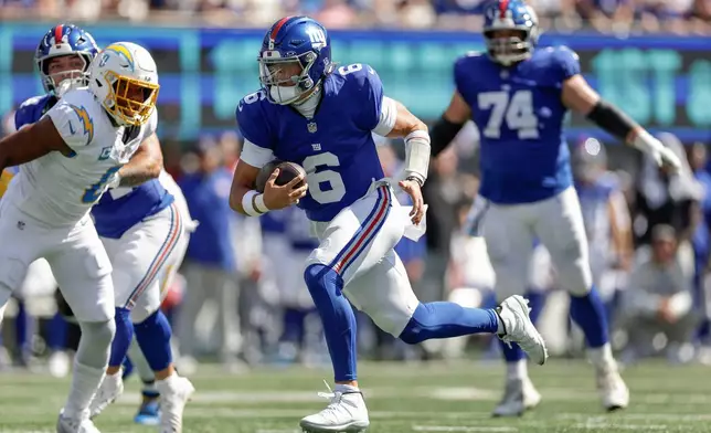 New York Giants quarterback Jaxson Dart (6) carries the ball for a touchdown against the Los Angeles Chargers during the first quarter of an NFL football game, Sunday, Sept. 28, 2025, in East Rutherford, N.J. (AP Photo/Adam Hunger)