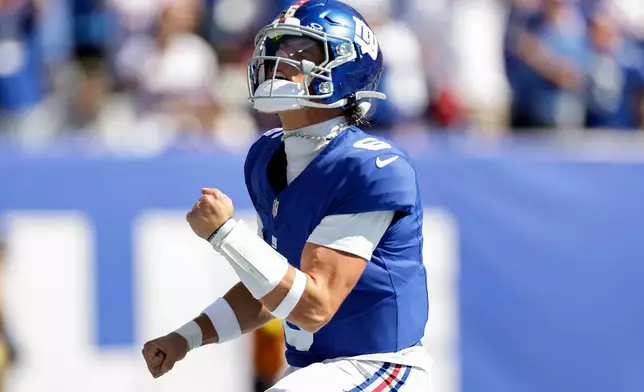 New York Giants quarterback Jaxson Dart (6) reacts after scoring a touchdown against the Los Angeles Chargers during the first quarter of an NFL football game, Sunday, Sept. 28, 2025, in East Rutherford, N.J. (AP Photo/Adam Hunger)