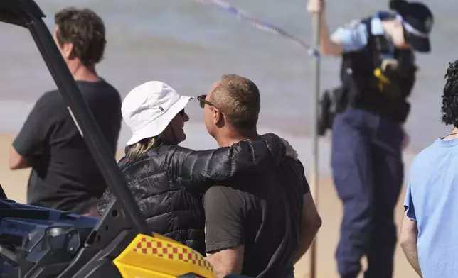People react at the site of a fatal shark attack at Dee Why Beach in Sydney, Australia, Saturday, Sept. 6, 2025. (AP Photo/Mark Baker)